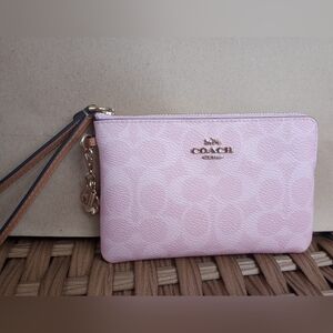 Coach | Corner Zip Wristlet in Powder Pink Signature Canvas With Flower Charm